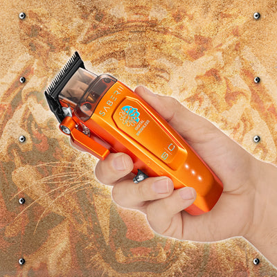 StyleCraft Saber 2 SC617O Orange clipper shown in hand
