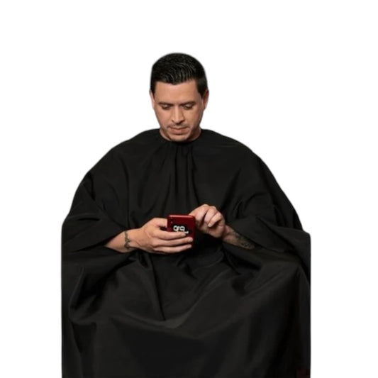 Barber Strong BSC12-BLKHF solid black hands-free cape worn by client using phone