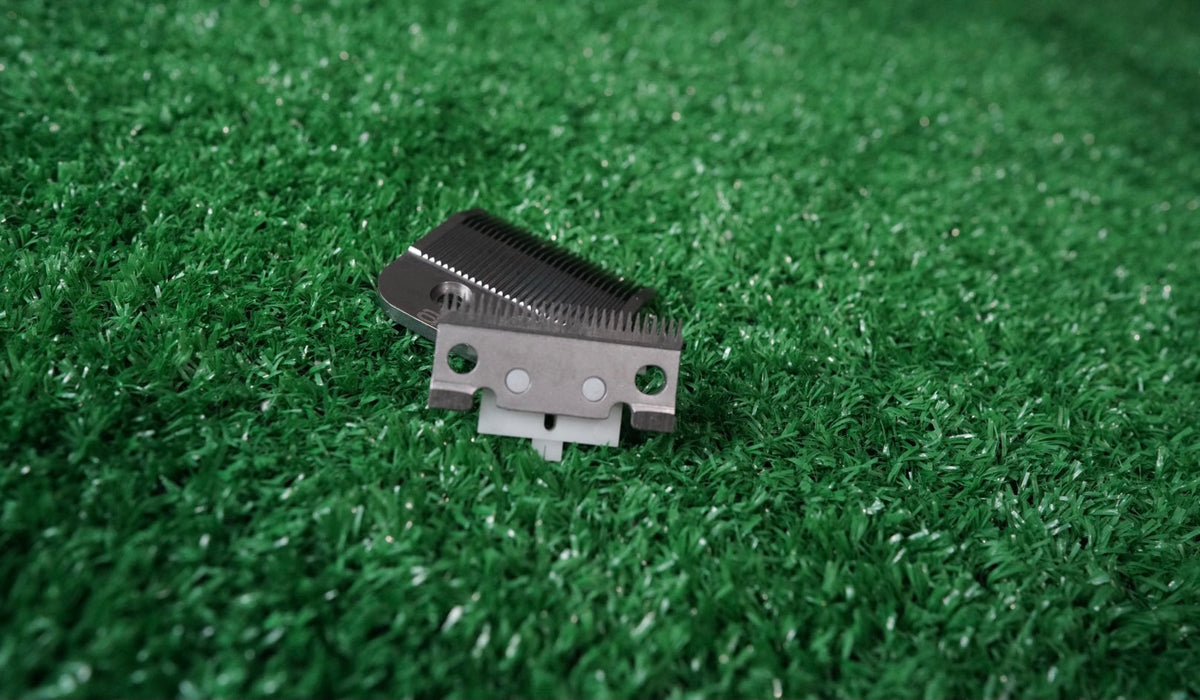 Philthy Blendz Gamma/StyleCraft to Andis Blade Cam – Clear – Andis blade and clear cam on green turf angled view