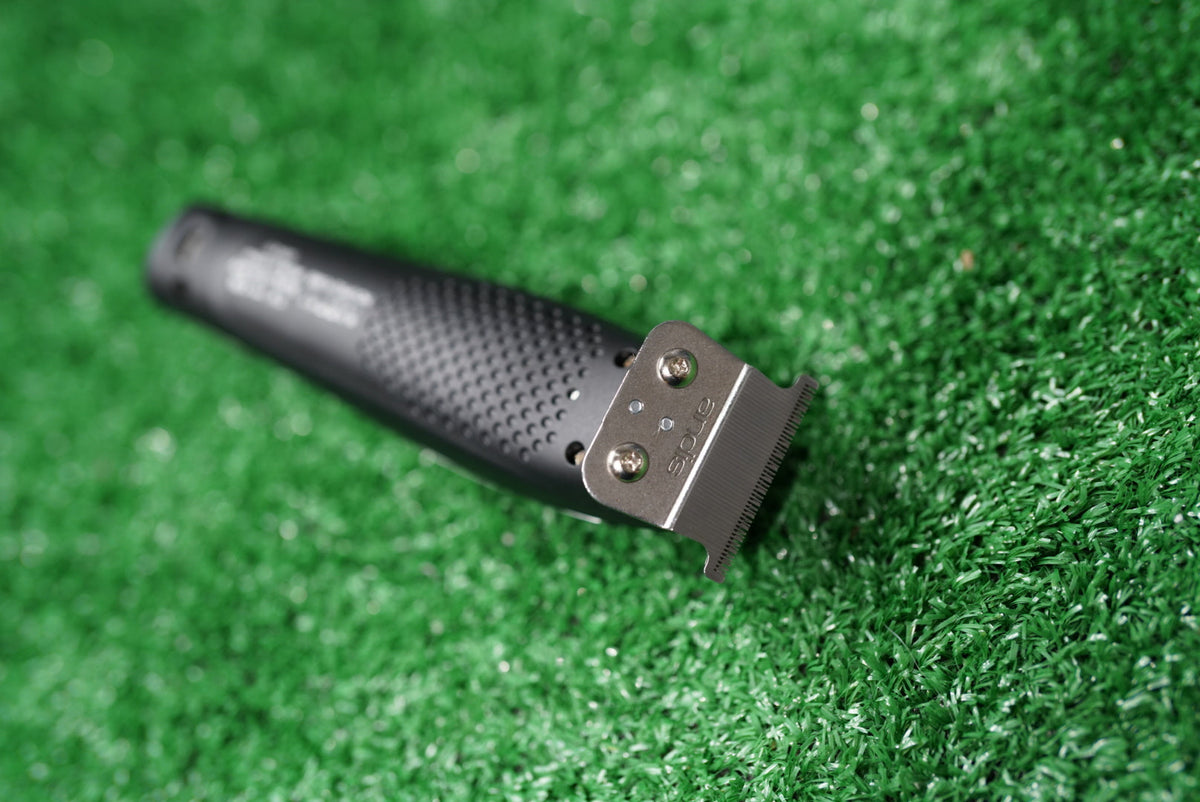 Philthy Blendz Gamma Evo 2.0 to Andis GTX Cam Follower – modified black trimmer lying on green turf