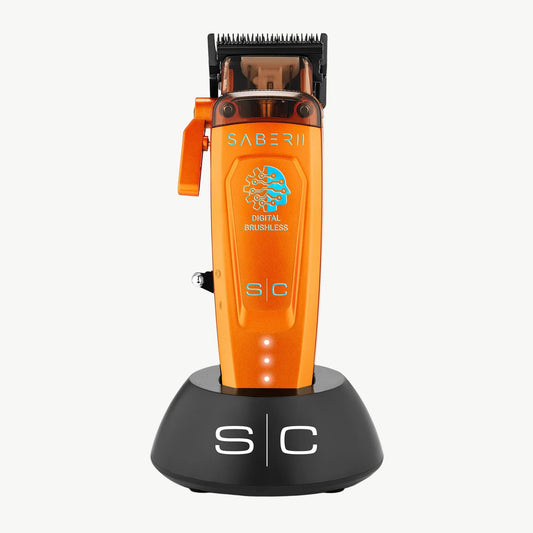 StyleCraft Saber 2 SC617O Orange professional clipper on charging stand